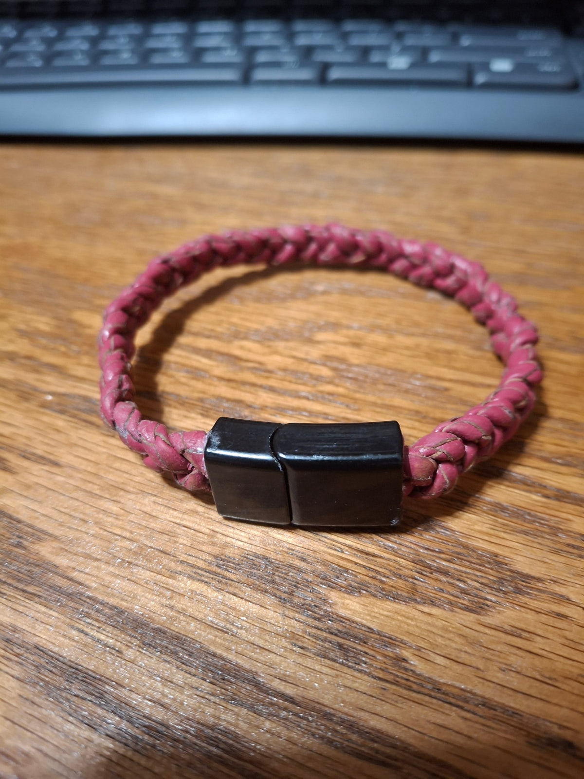 Red Bolo Bracelet with black metal clasp. 2 1/2" ID