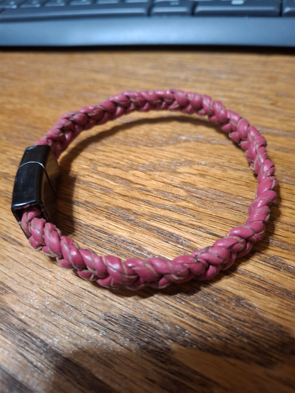 Red Bolo Bracelet with black metal clasp. 2 1/2" ID