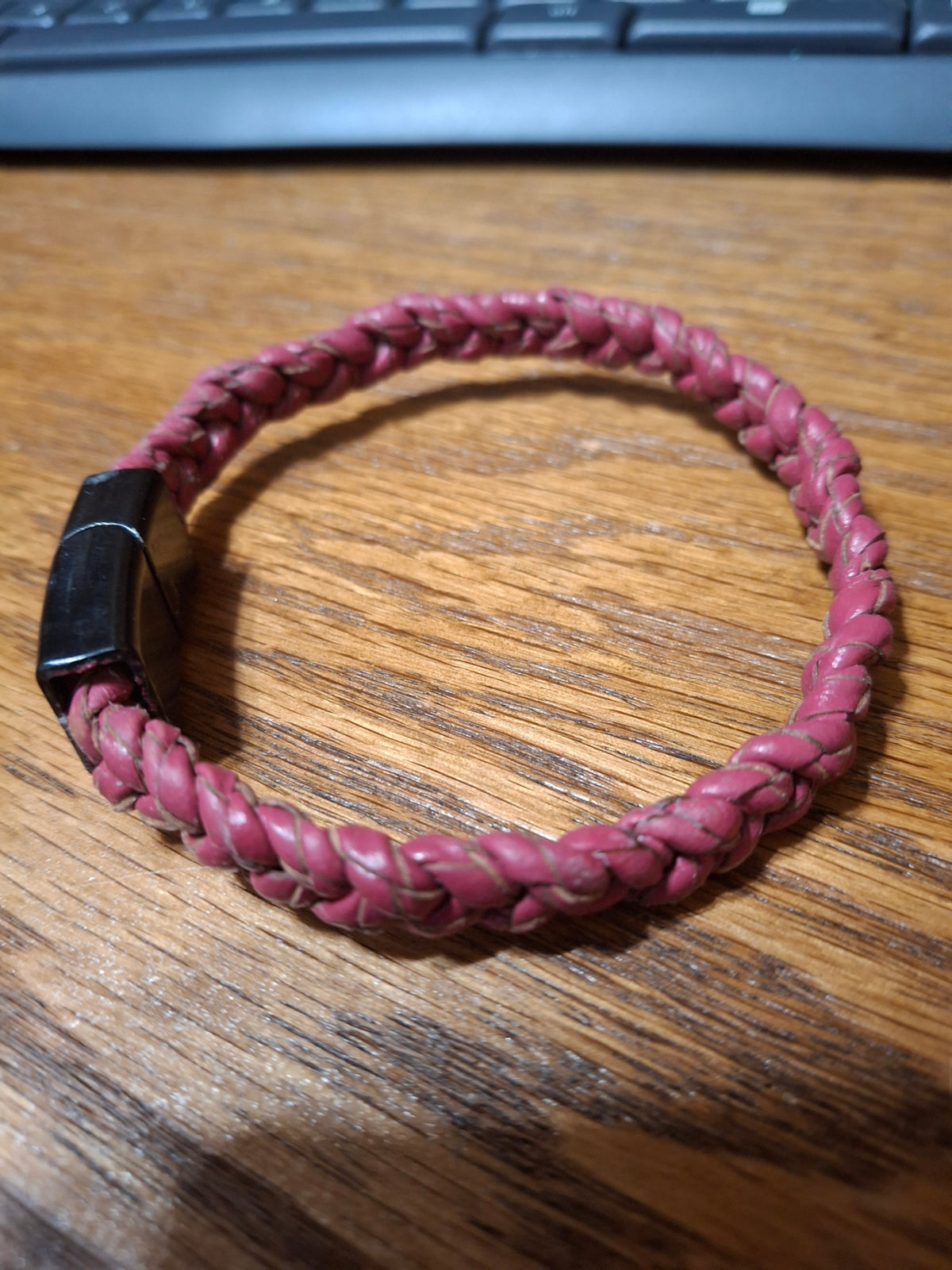 Red Bolo Bracelet with black metal clasp. 2 1/2" ID