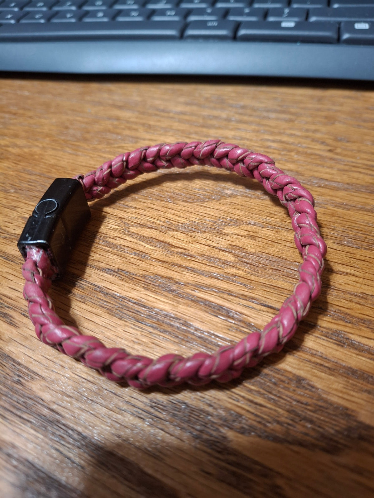 Red Bolo Bracelet with black metal clasp. 2 1/2" ID