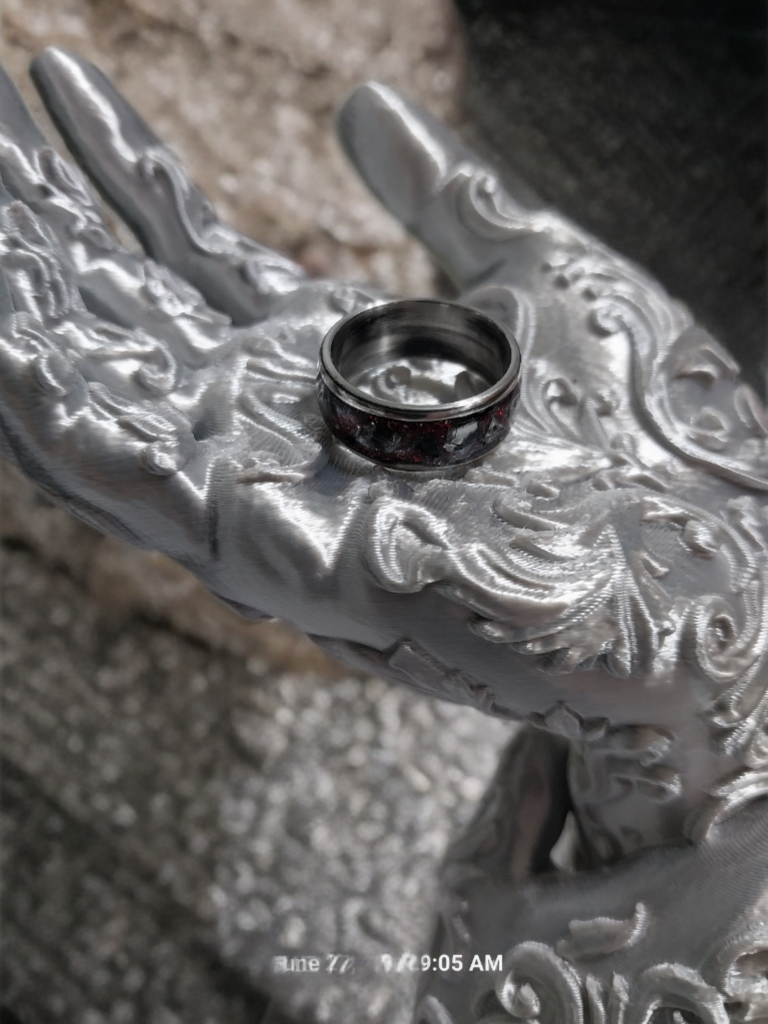 Handmade Ring. Clear stones with Red Glitter. Band is Stainless Steel. Size 7